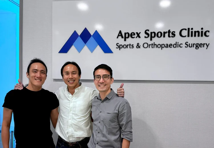 Dr Foo Gen Lin with patients at Apex Sports Clinic Singapore.